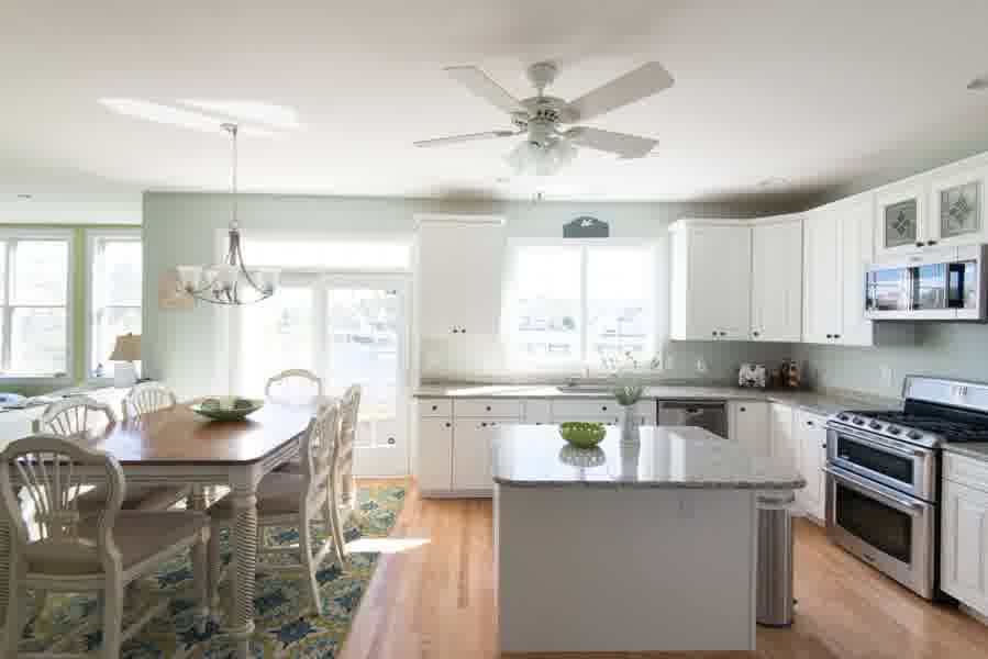 Sea Light renovated dining room and white kitchen
